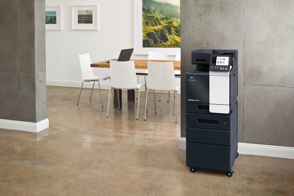 A Konica Minolta bizhub copier in a bright modern office