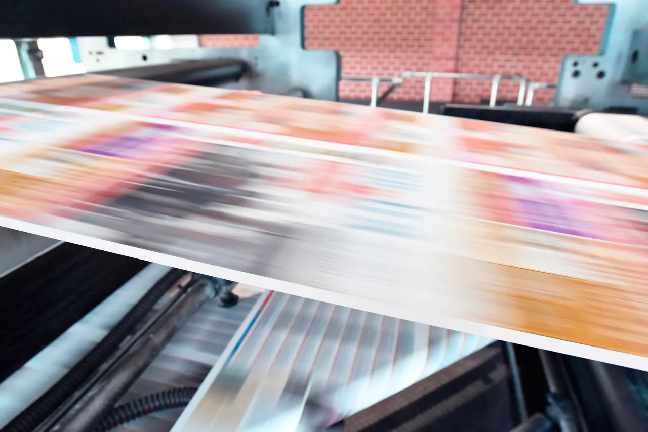 Printed sheets running at speed through a print press